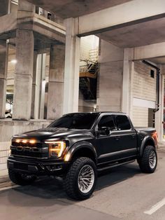 a black truck parked in front of a building