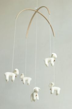 a mobile with white sheep hanging from it's sides