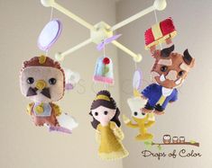 three small stuffed animals hanging from a ceiling