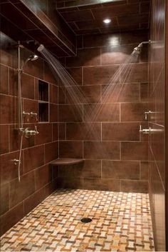 an image of a bathroom with tile flooring and brown wall tiles on the walls