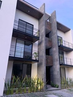 an apartment building with balconies on the second floor