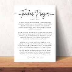 a teacher's prayer card on a wooden table