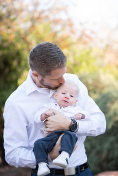 a man holding a baby in his arms