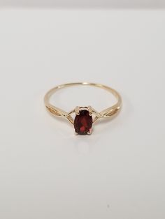 "Thanks for shopping our vintage estate store. We tend to sell well below wholesale and truly hope you enjoy all of our items. Many of the items are one of a kind, so please enjoy scrolling through the pictures and hopefully something will catch your eye. Brown spots are from reflections. Estate 10k yellow gold natural .50ct garnet midi or birthstone ring. Ring size: 7 Setting: 6mm by 4mm 1/4\" Band width: 1mm Weight: 1.0 gram Beautiful ring. Marked 10k." Classic Oval Ruby Ring With Diamond Cut, Heirloom Oval Ruby Ring With Diamond Cut, 14k Gold Oval Ruby Ring With Center Stone, Oval Ruby Ring In 14k Gold, Heirloom 14k Gold Oval Ruby Ring, Antique Oval Ruby Promise Ring, Classic 14k Gold Ruby Birthstone Ring, Heirloom Oval Ruby Ring In 14k Gold, Classic Oval Ruby Ring In 14k Gold