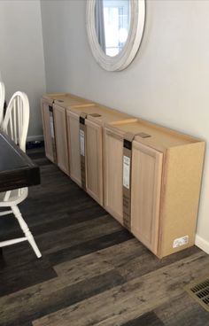 a room that has some cabinets on the floor and a table in front of it