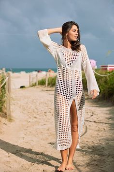 Model wears the Stella crochet cover up in white at the beach