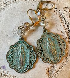 "Virgin Mary Madonna Earrings Verdigris green Patina over gold plated brass. They dangle from Czech Golden Shadow Crystals. The earrings are 2 1/2 \"s long and 1 1/4\" s wide. They will come gift boxed." Golden Shadow, Green Patina, Chocker Necklace, Czech Crystal, French Wire, Cotton Velvet, Austrian Crystal, Virgin Mary, Earrings Gold