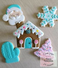 decorated cookies are arranged on a table with santa clause and snowflakes in the background