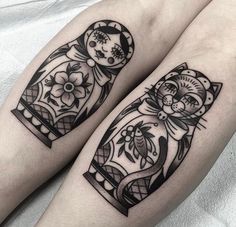 two black and white tattoos on both legs with cats in the middle one has a cat's head