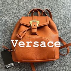 Very Beautiful Mini Backpack Mustard Color Luxury Backpack With Logo Hardware For Everyday Use, Luxury Backpack For Everyday Use With Logo Hardware, Luxury Leather Backpack For Shopping, Luxury Leather Shopping Backpack, Luxury Leather Backpack With Branded Hardware, Designer Backpack With Gold-tone Hardware, Luxury Backpack With Adjustable Strap For Errands, Luxury Brown Backpack With Branded Hardware, Versace Handbags