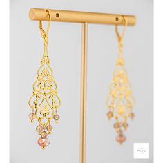 Add a touch of elegance and romance to your look with these stunning Amber glass filigree dangle earrings. The shimmering, faceted amber glass beads perfectly complement the lovely gold-plated filigree and lever backs, creating a lightweight and secure fit. Enhance your outfit with the timeless beauty of Amber glass filigree dangle earrings. The delicate filigree detailing and sparkling amber glass beads add a touch of sophistication and romance to any ensemble. These earrings, measuring at 2.75 Handmade Elegant Long Drop Chandelier Earrings, Elegant Beaded Bridal Earrings For Celebration, Elegant Dangle Beaded Earrings, Elegant Beaded Chandelier Earrings For Celebrations, Gold Elegant Beaded Earrings For Evening, Gold Czech Glass Earrings For Party, Elegant Nickel-free Czech Glass Teardrop Earrings, Party Gold Earrings With Czech Glass, Handmade Elegant Adjustable Chandelier Earrings