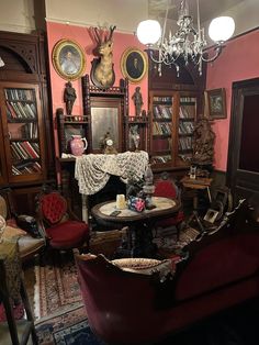 a living room filled with furniture and lots of books