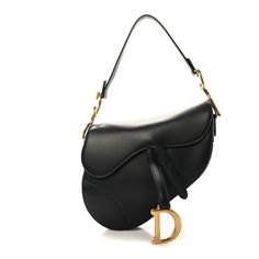 This is an authentic CHRISTIAN DIOR Calfskin Saddle Bag in Black. This chic bag is crafted of smooth calfskin leather in black. It features the saddle bag shape, a short leather shoulder strap with polished brass "C" and "D" anchors on either end of the handle for the handle, and a prominent hanging Dior "D" charm. The front flap opens to a black fabric interior with a zipper pocket. Monogram Tote, Chic Bags, Miss Dior, Saddle Bag, Zip Pouch, Lady Dior, Anchors, Polished Brass, Dior Saddle Bag