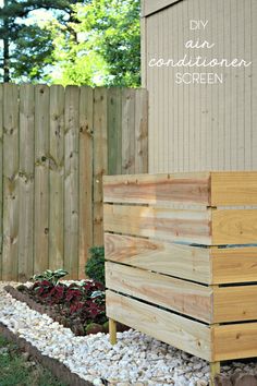 a wooden planter sitting next to a fence