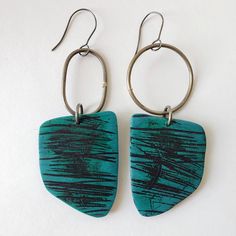 Teal and black polymer clay earrings featuring a playful design inspired by the sgraffito technique. This "Scribble" series is all handcrafted.  Teal and black polymer clay  meet durable steel, with visible soldered joins. Sterling silver fish hooks add a touch of sophistication. At approximately 0.2 oz each (5 grams each), they're a lightweight blend of style and comfort. Elevate your look with this artisanal OOAK creation. Handmade Black Contemporary Earrings, Contemporary Handmade Black Earrings, Black Polymer Clay Earrings, Sgraffito Technique, Fish Hooks, Silver Fish, Sgraffito, Black Steel, Playful Design