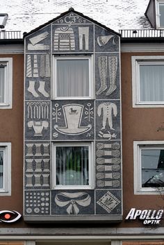 a building with many different designs painted on it's side and window sill