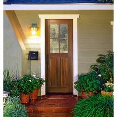 the front door of a house with potted plants