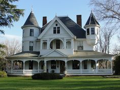 a large white victorian style house with two towers