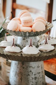 cupcakes and pastries are displayed on a cake stand