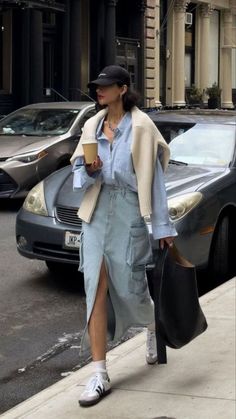 Long denim skirt, with blue button up, beige sweater over the shoulders, and Sambas Spring Outfits Korea, Long Denim Skirt Outfits, Skirt Outfits For Women, Korea Street Style