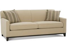 a beige couch with striped pillows on it