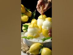 someone is decorating some lemons with ice cream