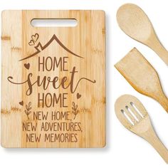 wooden cutting board with utensils and spoons next to it that says home sweet home