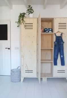 two wooden lockers with clothes hanging on them