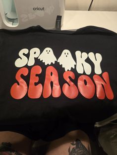 Made to order spooky season shirt! This is fully customizable, please dm with the color shirt, size and the color vinyl you would like! I can also make this with glitter vinyl! Ex) L black tshirt with pink vinyl Spooky Black T-shirt With Screen Print, Black Fun T-shirt With Custom Print, Fun Black T-shirt With Custom Print, Black T-shirt With Heat Transfer Vinyl Band Merch, Black Spooky Letter Print T-shirt, Cute Shirt Designs Vinyl, Pink Vinyl, Cute Shirt Designs, Vinyl Shirts