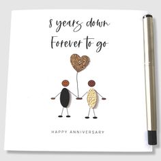 an anniversary card with two people holding hands and a heart shaped balloon in the middle