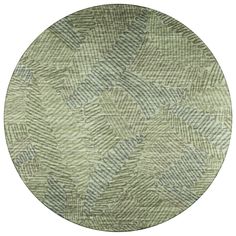 a round rug with green leaves on it