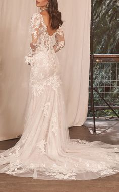 the back of a wedding dress with long sleeves