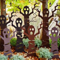 halloween yard decorations with trees and creepy faces