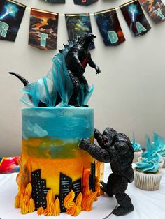 a godzilla and godzilla cupcake on a table