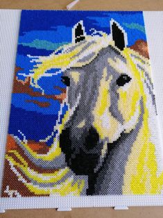 a close up of a painting of a horse with blonde hair and blue sky in the background