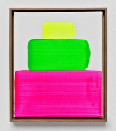 an abstract painting with pink, green and yellow colors in a wooden frame on a white wall