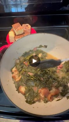 a white bowl filled with food on top of a stove