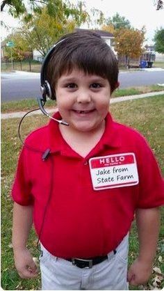 a young boy wearing a headset with a name tag on his shirt that says help