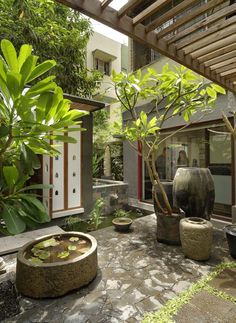 an outdoor courtyard with potted plants and water features