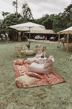 some chairs and umbrellas in the grass