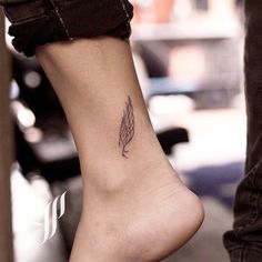 a woman's foot with a small tattoo on the side of her left leg