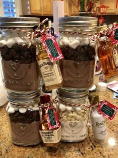 mason jars filled with hot chocolate, marshmallows and other treats for christmas