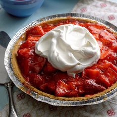 a strawberry pie with whipped cream on top