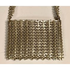 French designer Paco Rabanne is best known for his revolutionary 1968 dresses made from metal discs and rings. This rare handbag soon followed, made from the same materials. The bag has a shoulder strap, an interior silver leather pouch which has a metal zipper, a fabric lining, and the Paco Rabanne label.  It is in excellent condition, with very minor loss to the finish on three of the discs making up the shoulder strap. Measurements; Length 9"  Height 6"  Depth 1.5" Modern Metal Bags For Formal Occasions, Metallic Metal Evening Bag, Metallic Metal Evening Bags, Silver Metal Chainmail Bag, Silver Metal Rectangular Shoulder Bag, Silver Rectangular Metal Shoulder Bag, Elegant Evening Shoulder Bag With Chainmail, Rectangular Silver Metal Shoulder Bag, Vintage Evening Shoulder Bag With Metal Hardware