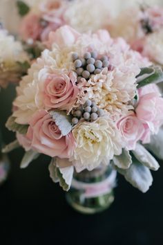 a vase filled with pink and white flowers on top of a wooden table next to an instagram page