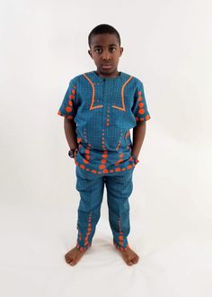 Boys African Traditional outfit. Add to your child's wardrop our boys Eva African - print ,made with 100% cotton poplin Ankara -African wax. Vibrant and stylish.  Features of this Boys African clothing  Short sleeve buttoned chest waist rubber band  2 side pockets  Big fashion , little prices.  Care Instruction: HAND WASH COLD. MILD DETERGENT. DO NOT BLEACH. HANG TO DRY. Kitenge Tops, Outfit Short, Traditional Outfit, Boys Set, Big Fashion, African Inspired, Rubber Band, Black Kids, African Clothing