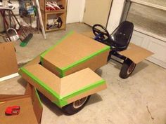 three boxes are stacked on top of one another in a garage with a scooter