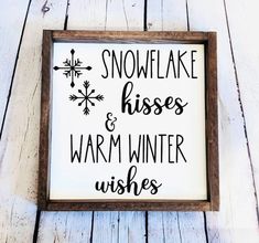 a wooden sign that says snowflake kisses and warm winter wishes on white wood planks