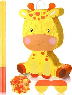 a wooden toy giraffe sitting next to a yellow stick and orange crayons