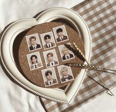 a heart shaped plate with pictures of people in it on a checkered table cloth